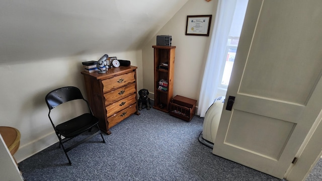 living area featuring carpet flooring and lofted ceiling