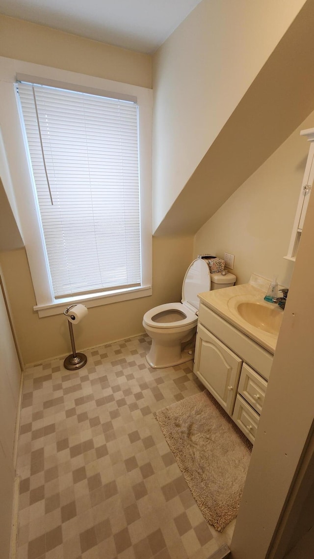 bathroom featuring toilet and vanity