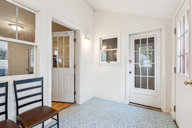 interior space with baseboards and vaulted ceiling