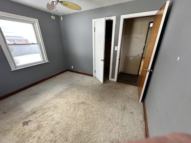 unfurnished bedroom with baseboards and carpet