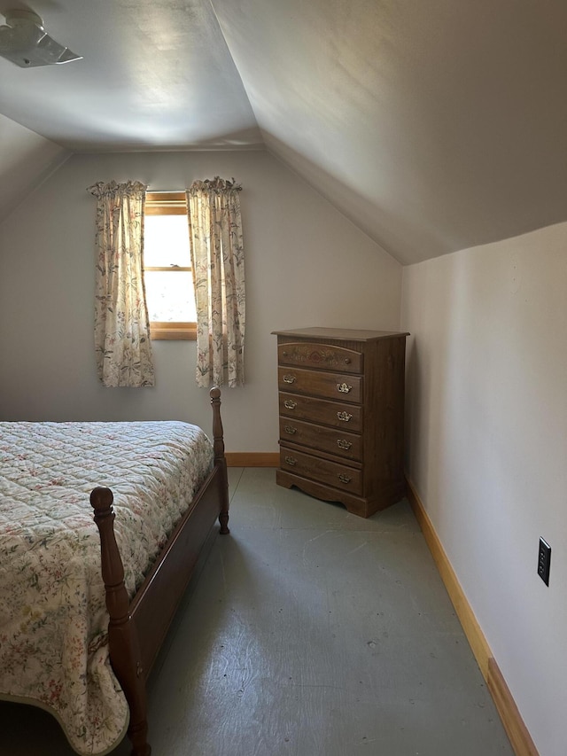 bedroom featuring baseboards, lofted ceiling, and light carpet