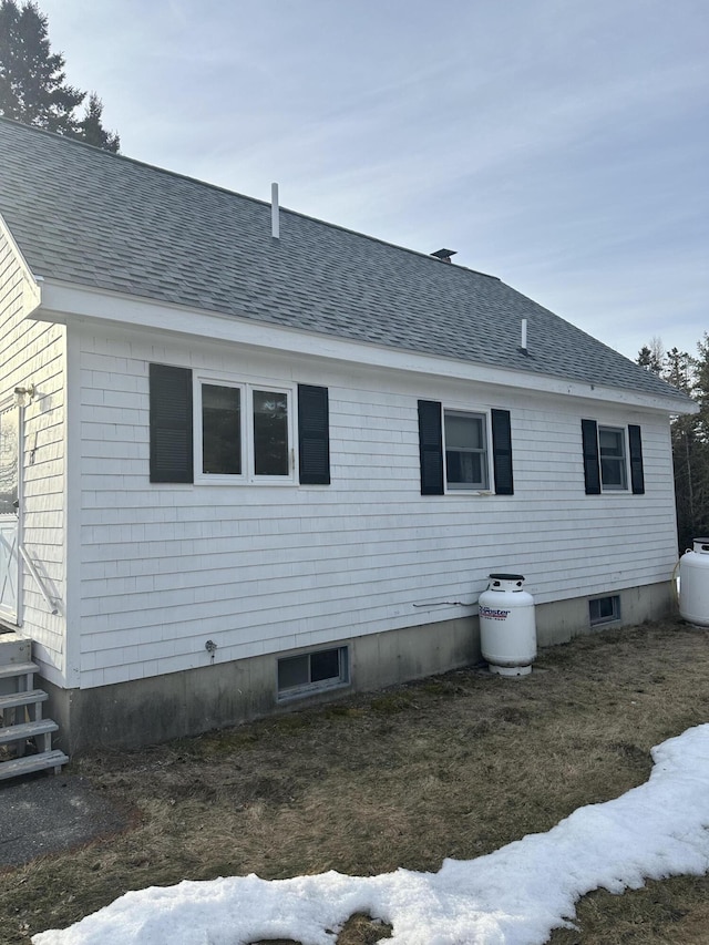 view of home's exterior with a shingled roof