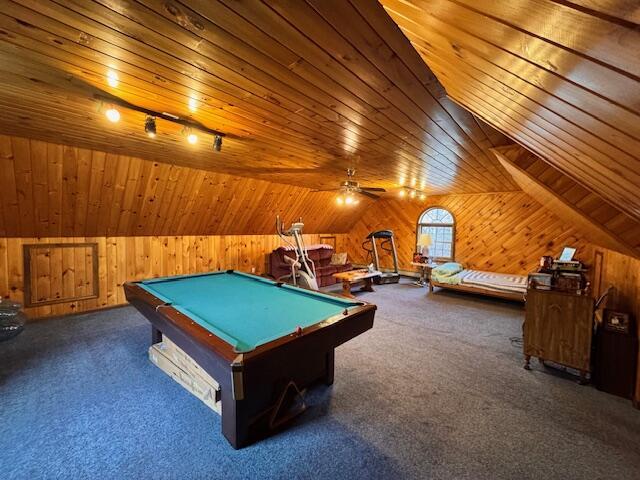 rec room with wood ceiling, carpet flooring, rail lighting, and wooden walls