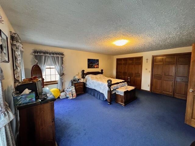 bedroom featuring two closets and dark carpet
