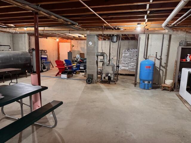 unfinished basement featuring heating fuel and a heating unit