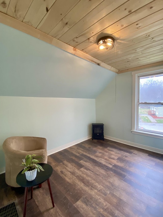 additional living space with dark wood-type flooring, wood ceiling, baseboards, and vaulted ceiling