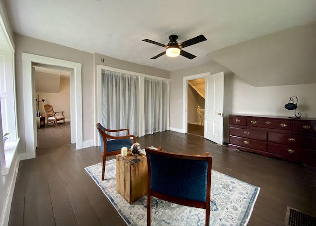 living area featuring baseboards, a ceiling fan, dark wood-style flooring, and visible vents