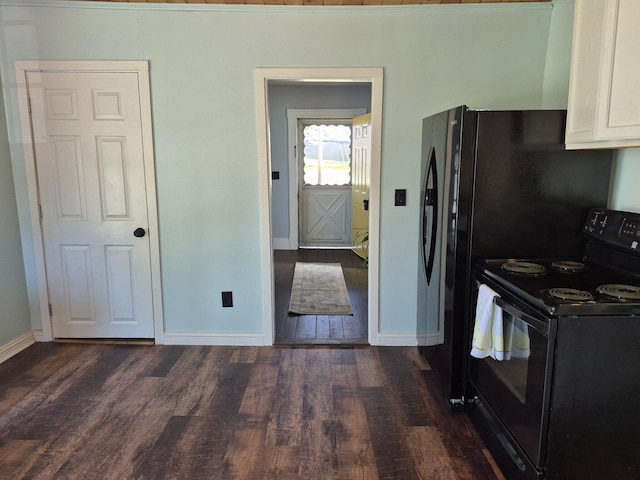 kitchen with baseboards, dark wood finished floors, black electric range, and white cabinetry