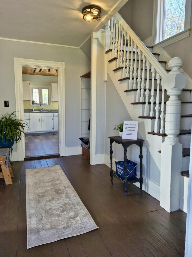 foyer featuring baseboards, stairs, and hardwood / wood-style flooring