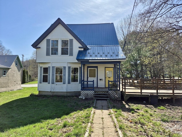 view of front of property with a front yard and metal roof