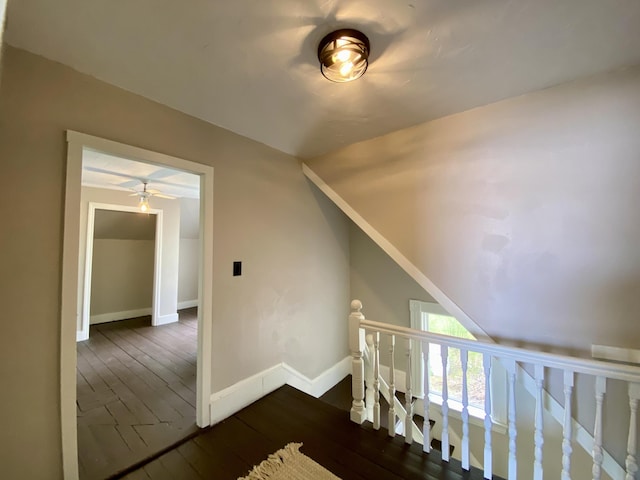 bonus room featuring dark wood-style floors, baseboards, and a ceiling fan