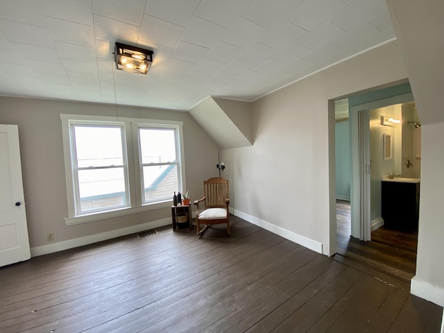 unfurnished room featuring dark wood-type flooring and baseboards