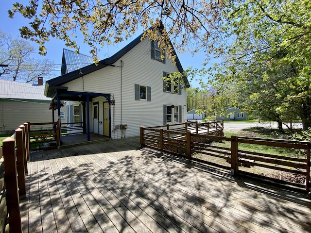 rear view of house featuring a wooden deck