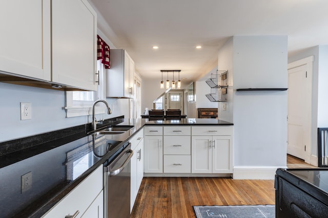 kitchen featuring a sink, dark wood-type flooring, decorative light fixtures, white cabinetry, and stainless steel dishwasher