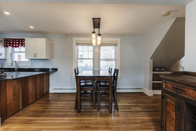 dining space with recessed lighting, a baseboard heating unit, baseboards, and dark wood-style flooring