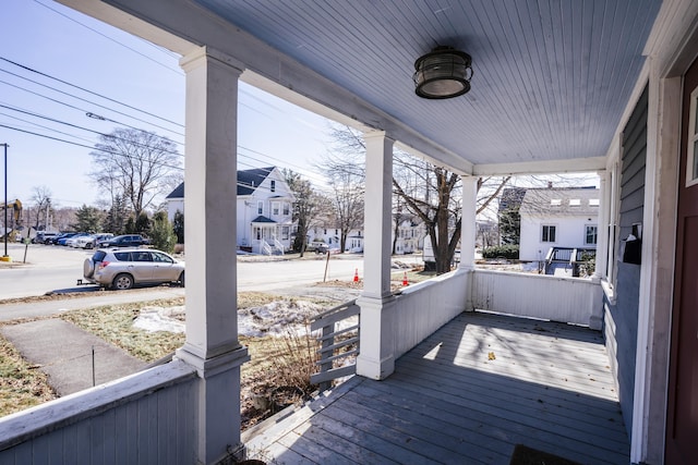 wooden deck with a porch and a residential view