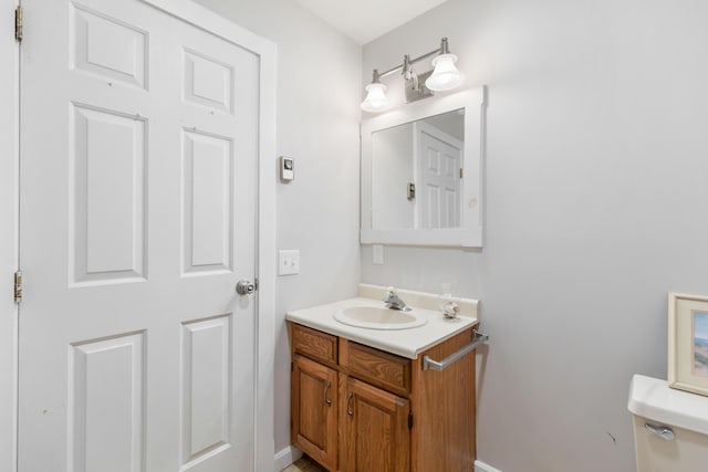 half bathroom with toilet and vanity