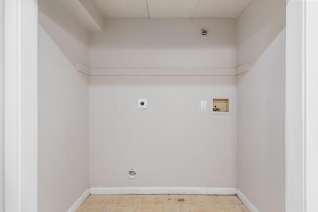 laundry room with electric dryer hookup, baseboards, light floors, hookup for a washing machine, and laundry area