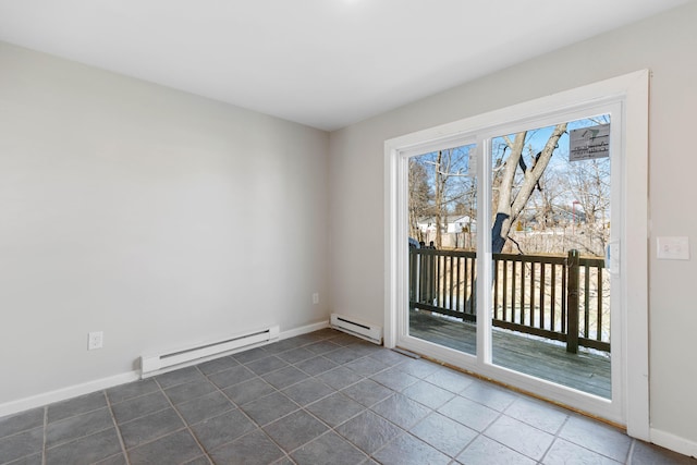 unfurnished room featuring a baseboard heating unit, baseboards, and dark tile patterned floors