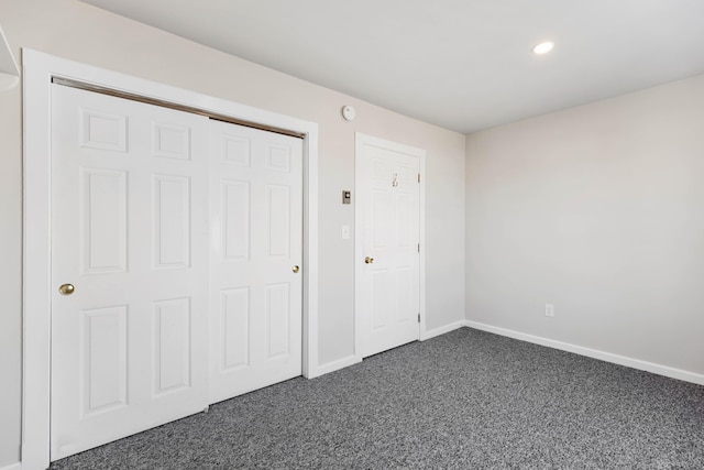 unfurnished bedroom featuring recessed lighting, baseboards, and dark colored carpet