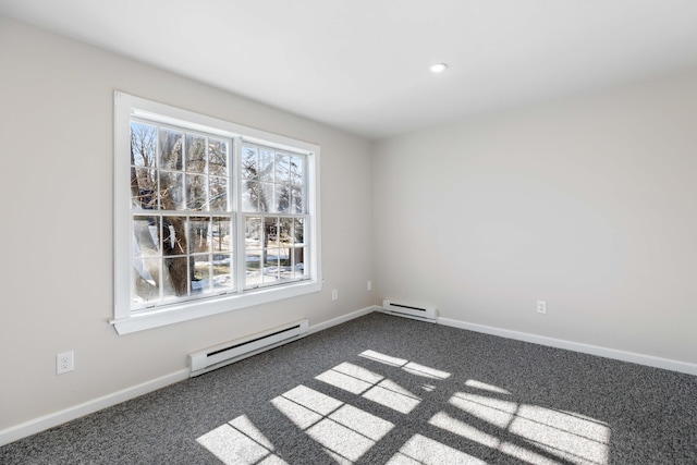 unfurnished room with a baseboard radiator, baseboards, and dark carpet