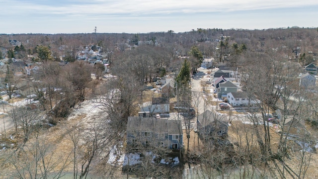 drone / aerial view with a wooded view