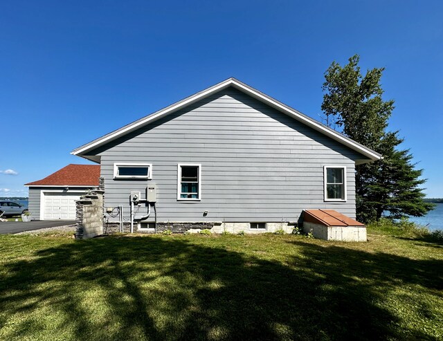 68 Robbins St, Robbinston, ME 04671 - view of property exterior with a yard, a garage, and driveway