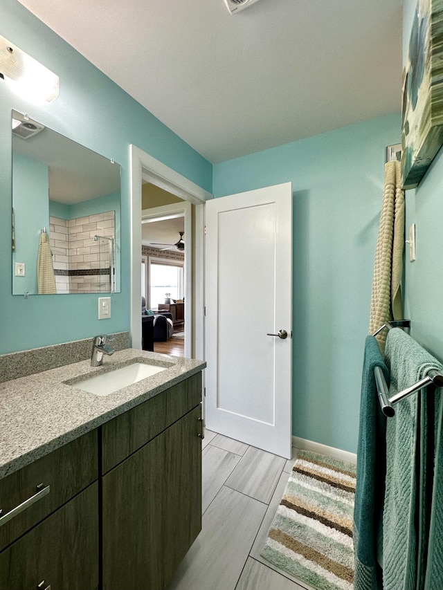 68 Robbins St, Robbinston, ME 04671 - bathroom featuring vanity, baseboards, visible vents, and connected bathroom
