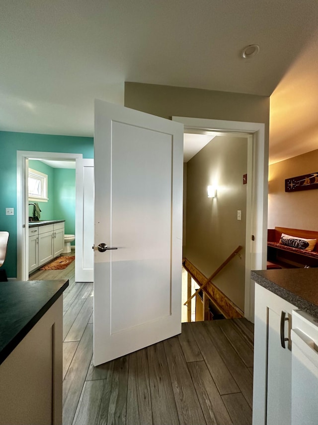 68 Robbins St, Robbinston, ME 04671 - hallway featuring wood finished floors and an upstairs landing