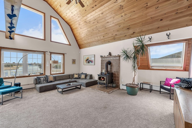 452 Milbridge Rd, Cherryfield, ME 04622 - living room featuring a wood stove, carpet, wood ceiling, a baseboard radiator, and baseboard heating
