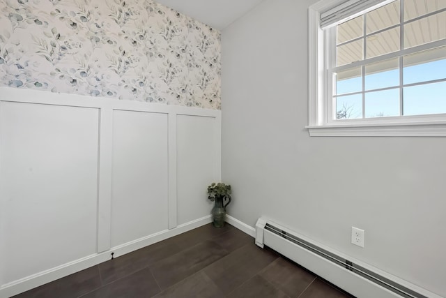63 Grandview Dr, Newport, ME 04953 - empty room with a decorative wall, wallpapered walls, a baseboard heating unit, wainscoting, and baseboards