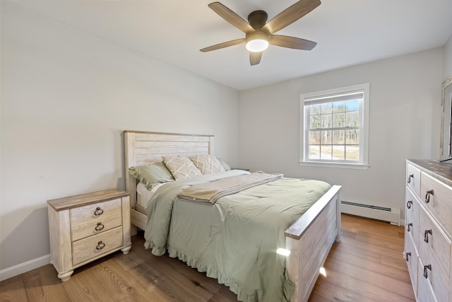 63 Grandview Dr, Newport, ME 04953 - bedroom featuring baseboards, light wood finished floors, baseboard heating, and a ceiling fan