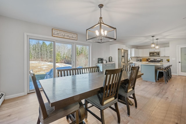 63 Grandview Dr, Newport, ME 04953 - dining area with baseboards, a notable chandelier, and light wood-style floors