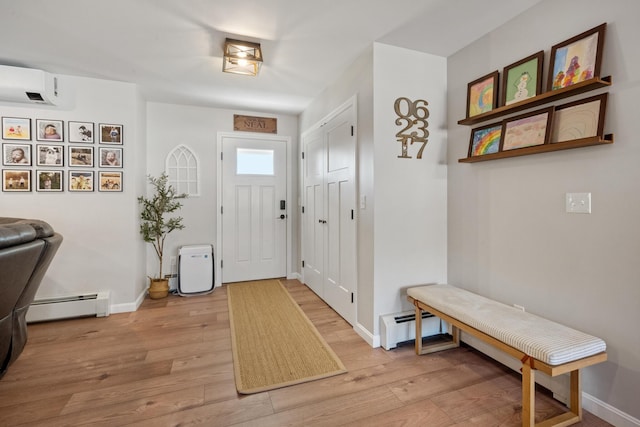 63 Grandview Dr, Newport, ME 04953 - foyer featuring a baseboard heating unit, baseboards, a wall mounted AC, and light wood-style flooring