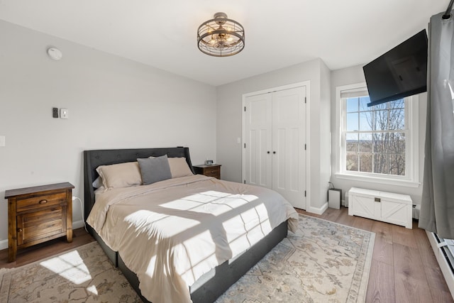 63 Grandview Dr, Newport, ME 04953 - bedroom with a chandelier, wood finished floors, a closet, and baseboards
