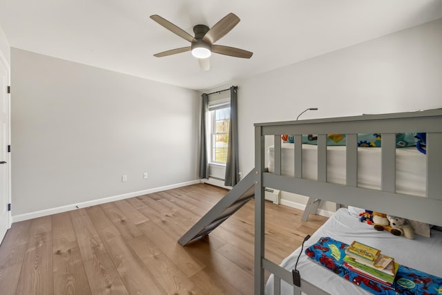 63 Grandview Dr, Newport, ME 04953 - bedroom with baseboards, a ceiling fan, wood finished floors, and a baseboard radiator