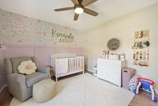 63 Grandview Dr, Newport, ME 04953 - bedroom with a nursery area, baseboards, a ceiling fan, and wood finished floors