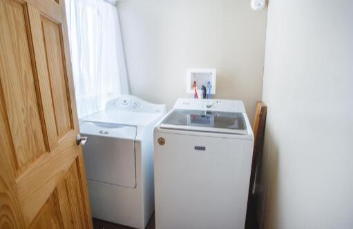 washroom with washing machine and dryer and laundry area