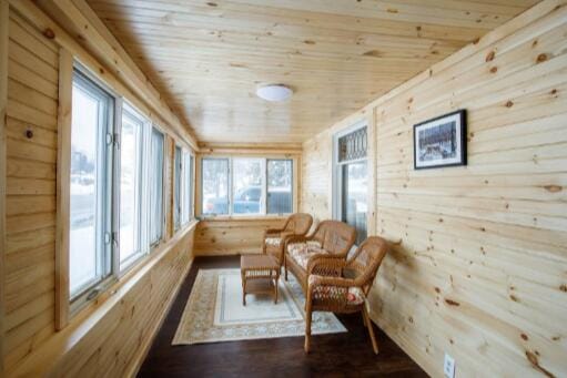 sunroom / solarium featuring wood ceiling