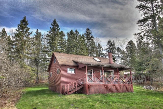 62 Hernborg Rd, Rangeley, ME 04970 - back of house with a chimney, a lawn, covered porch, and a shingled roof