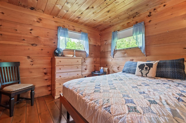 62 Hernborg Rd, Rangeley, ME 04970 - bedroom with multiple windows, hardwood / wood-style floors, wood walls, and wooden ceiling
