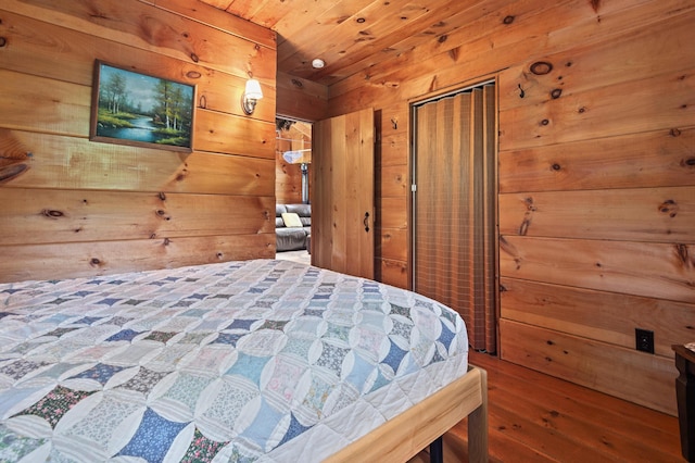 62 Hernborg Rd, Rangeley, ME 04970 - bedroom with wooden walls, wood finished floors, a closet, and wood ceiling