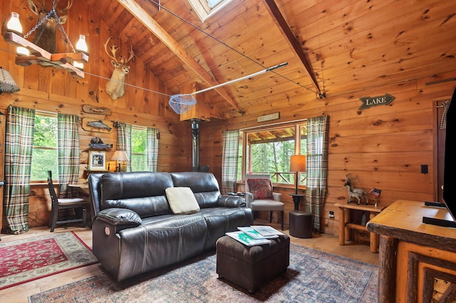 62 Hernborg Rd, Rangeley, ME 04970 - living area with wood walls, plenty of natural light, a wooden ceiling with exposed beams, a skylight, and a wood stove