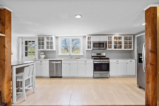 30 Joy Valley Rd, Buxton, ME 04093 - kitchen with appliances with stainless steel finishes, a sink, light countertops, glass insert cabinets, and recessed lighting