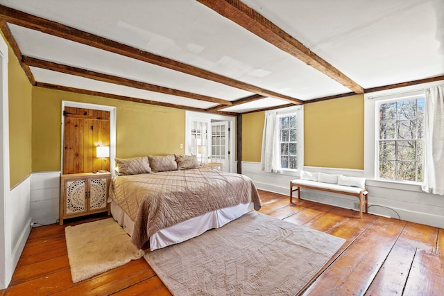 30 Joy Valley Rd, Buxton, ME 04093 - bedroom with hardwood / wood-style flooring, beamed ceiling, and a wainscoted wall
