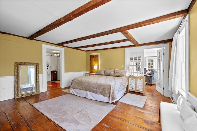 30 Joy Valley Rd, Buxton, ME 04093 - bedroom featuring wood-type flooring, beam ceiling, french doors, and wainscoting