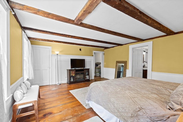 30 Joy Valley Rd, Buxton, ME 04093 - bedroom featuring hardwood / wood-style floors, beamed ceiling, a wainscoted wall, and a fireplace