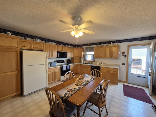 kitchen with a ceiling fan, light floors, a sink, black appliances, and light countertops