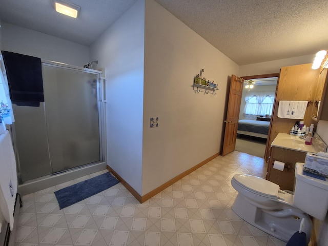 bathroom with connected bathroom, toilet, a stall shower, and a textured ceiling