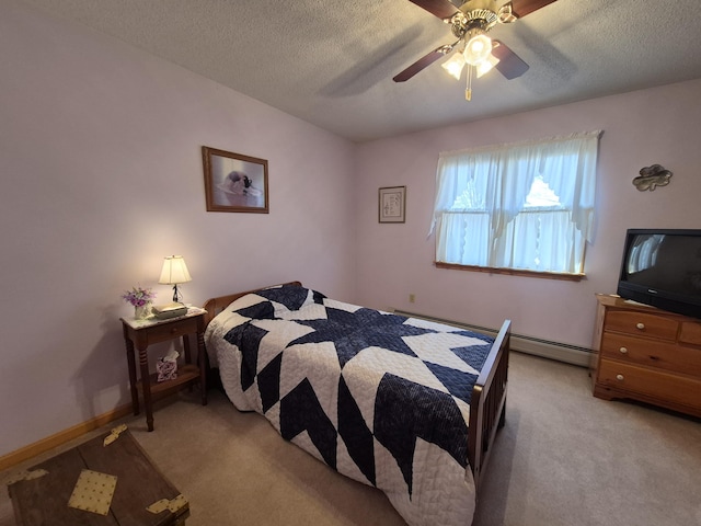 bedroom featuring a baseboard radiator, light colored carpet, a ceiling fan, and a textured ceiling